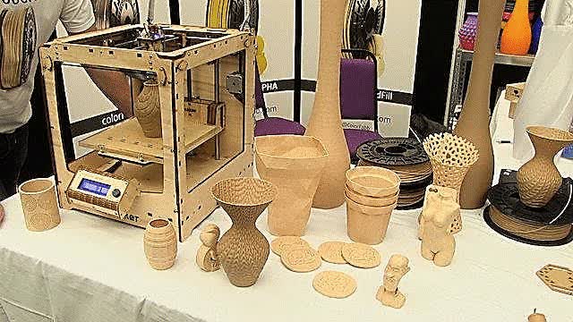 Figure 1. 3D wood printer and printed models.